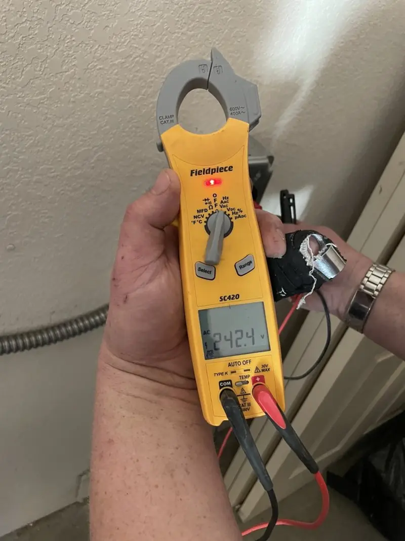 Voltage testing with clamp meter during Whole House Surge Protector in Wills Point